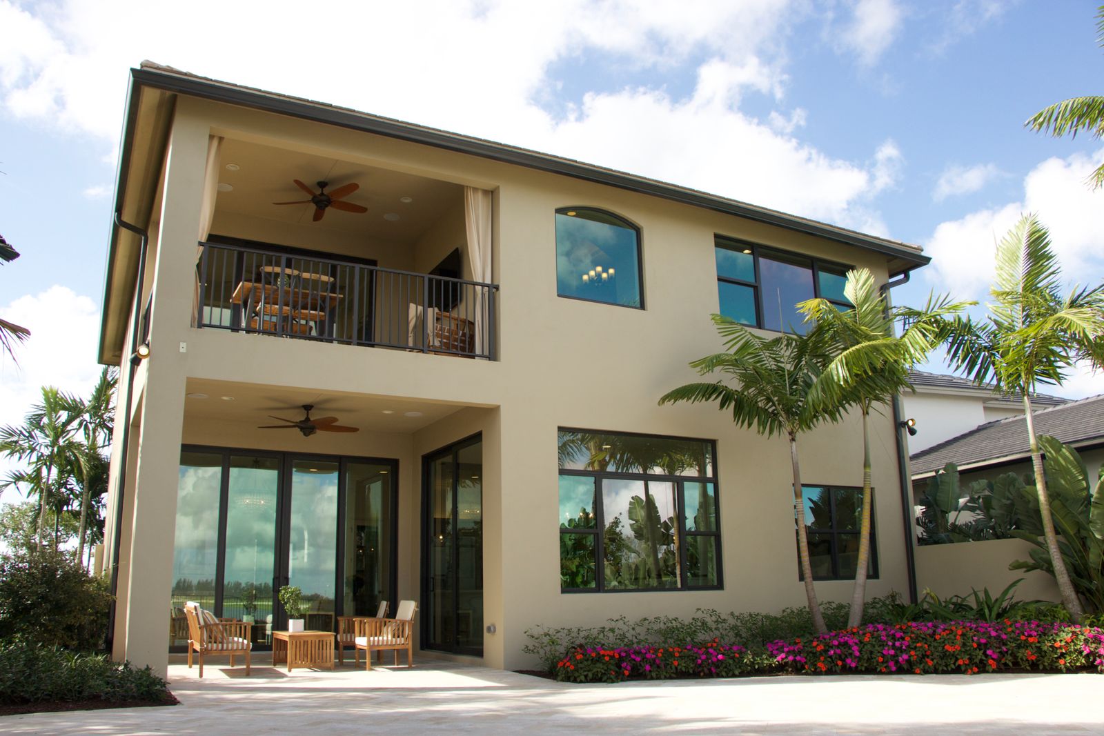 Florida home exterior with a shaded patio and tropical landscaping